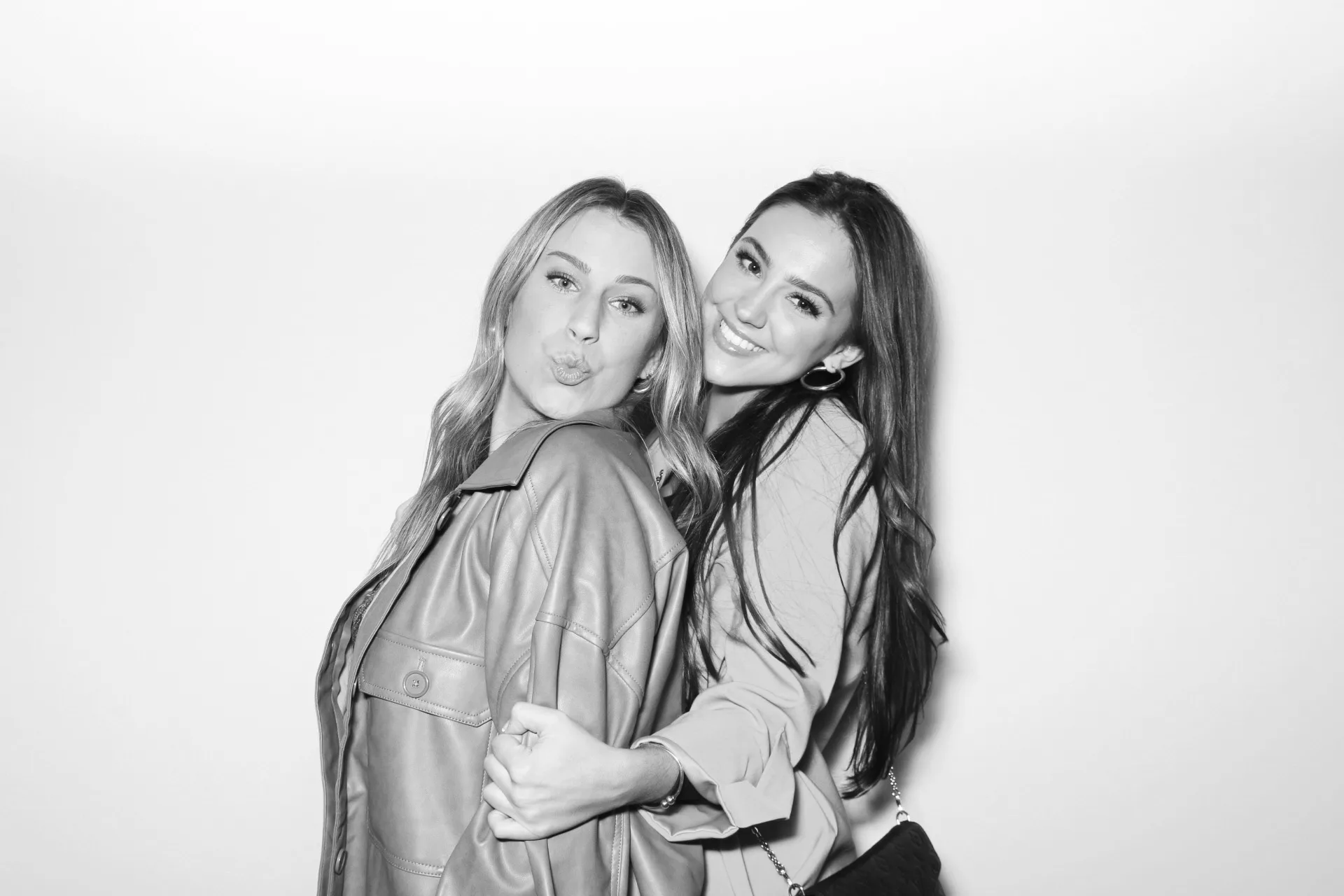 Allure Booth black and white portrait of two friends in leather jackets