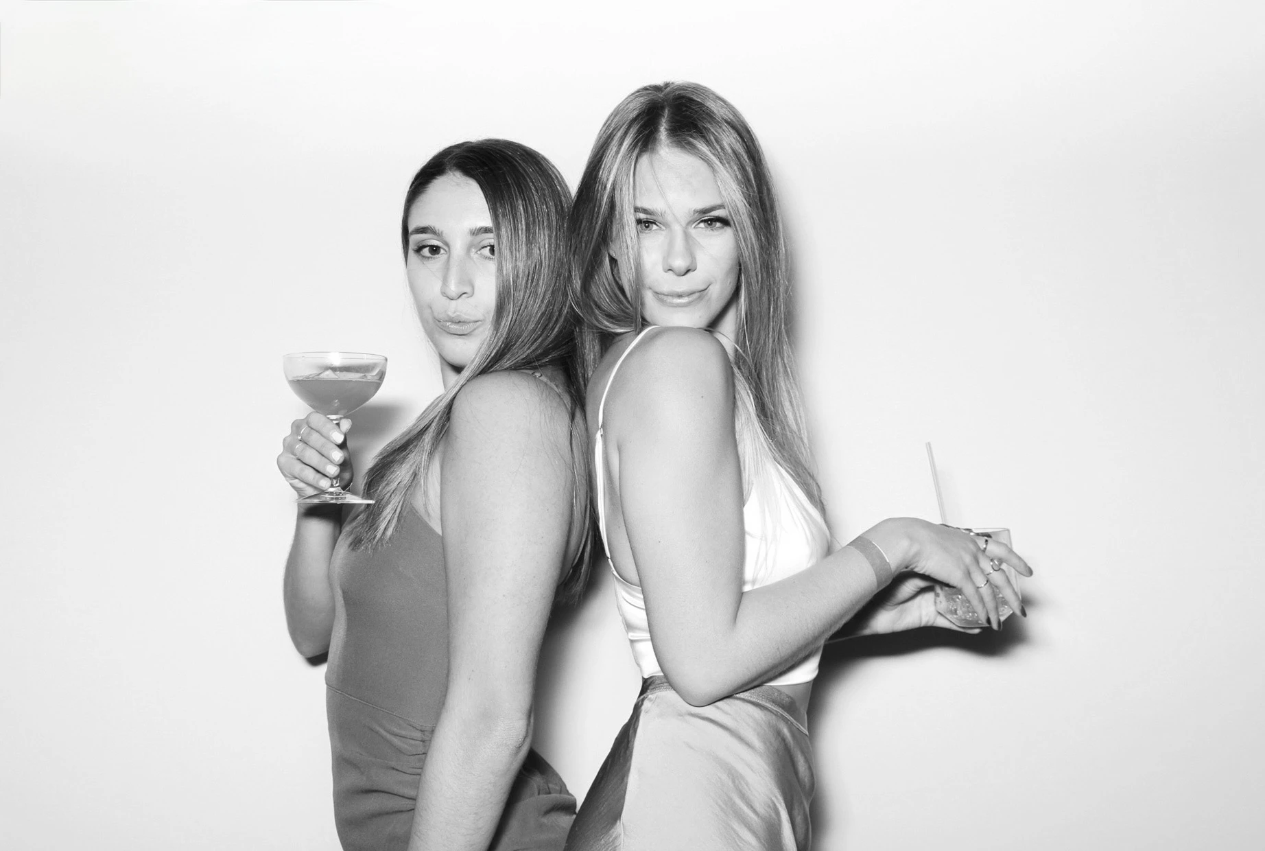 Allure Booth black and white portrait of two friends with cocktails