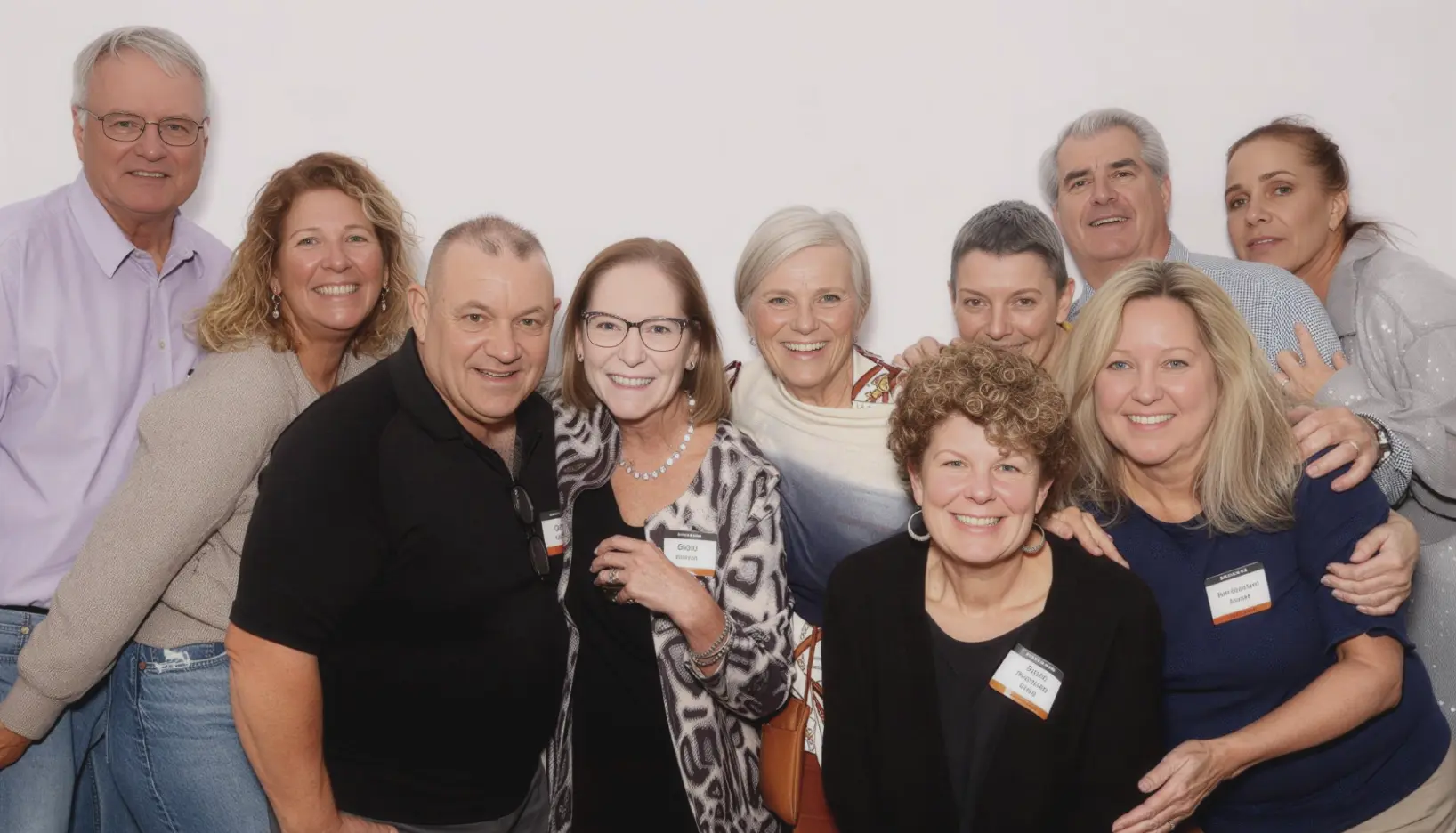 Group of classmates posing together at a class reunion photo booth