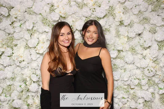 Flower wall photo booth with lush pink and white roses at an elegant event
