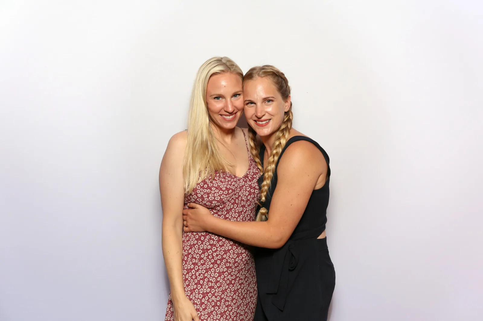 Two friends posing together in The Lux Booth