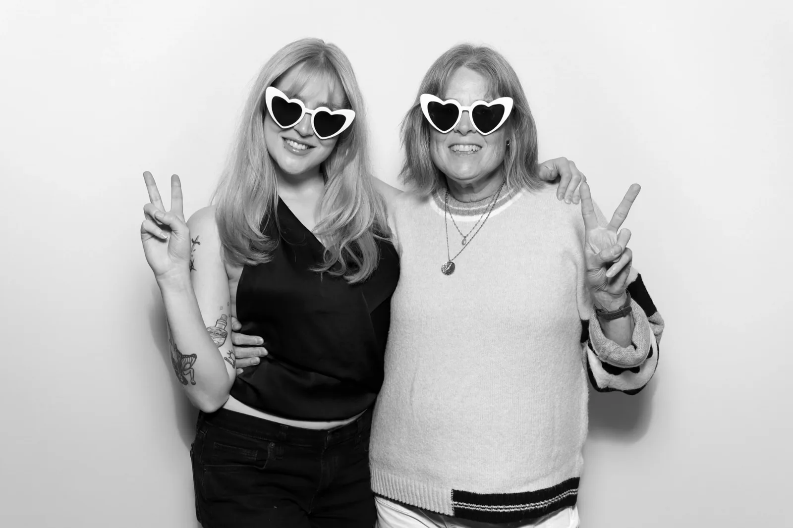 Two guests with heart-shaped sunglasses in The Lux Booth