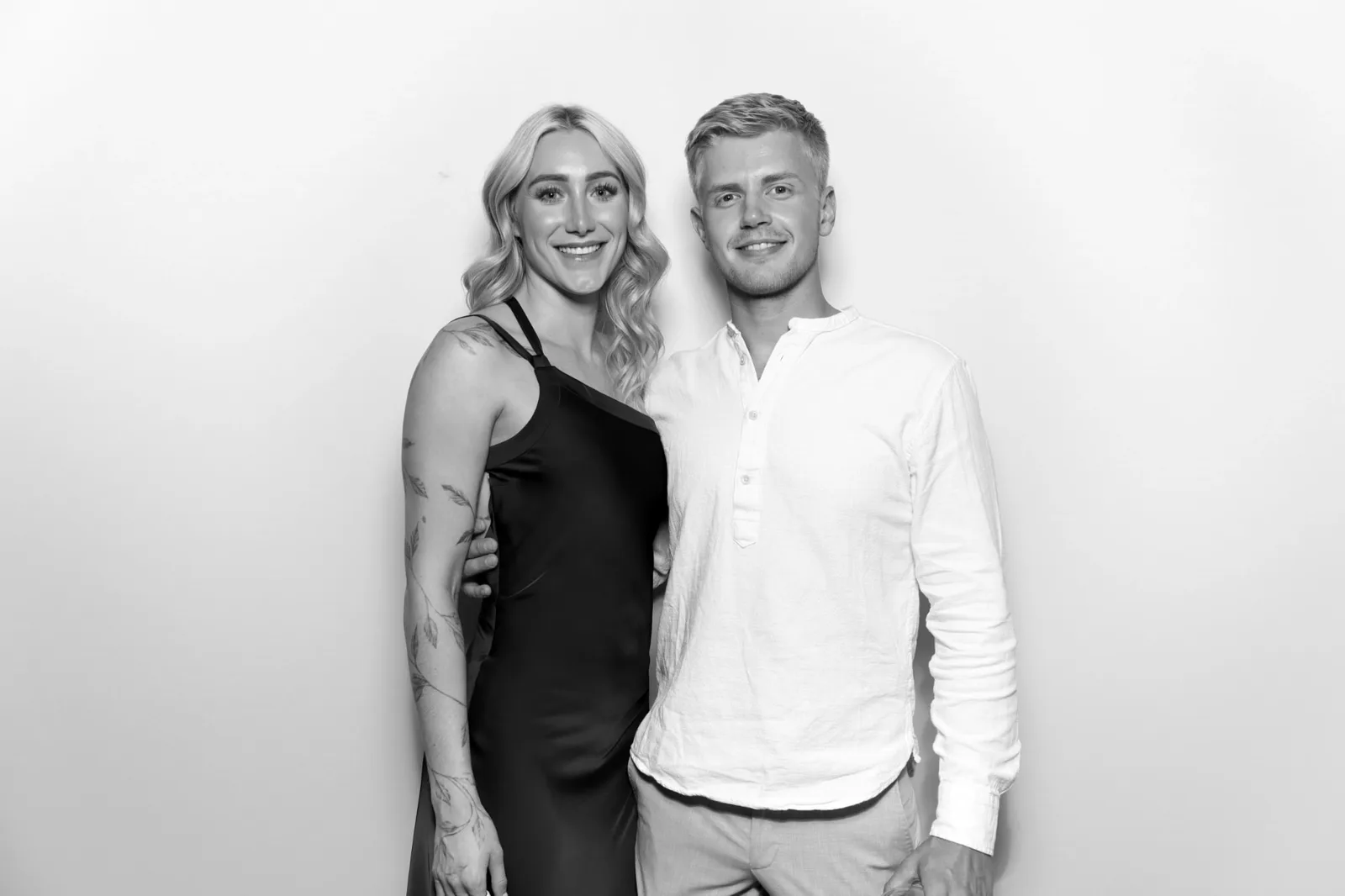 A couple posing in The Lux Booth at a wedding