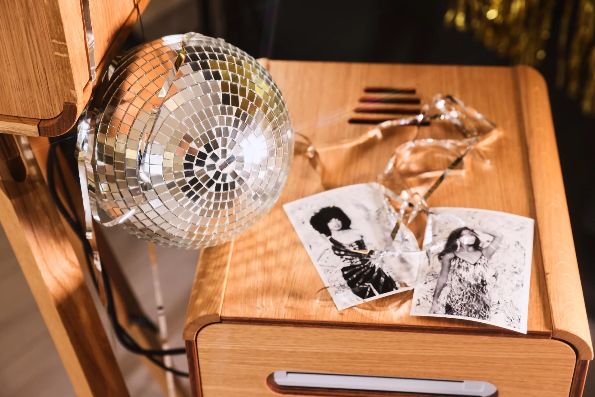 Black and white photo prints beside the handcrafted oak Lux Booth