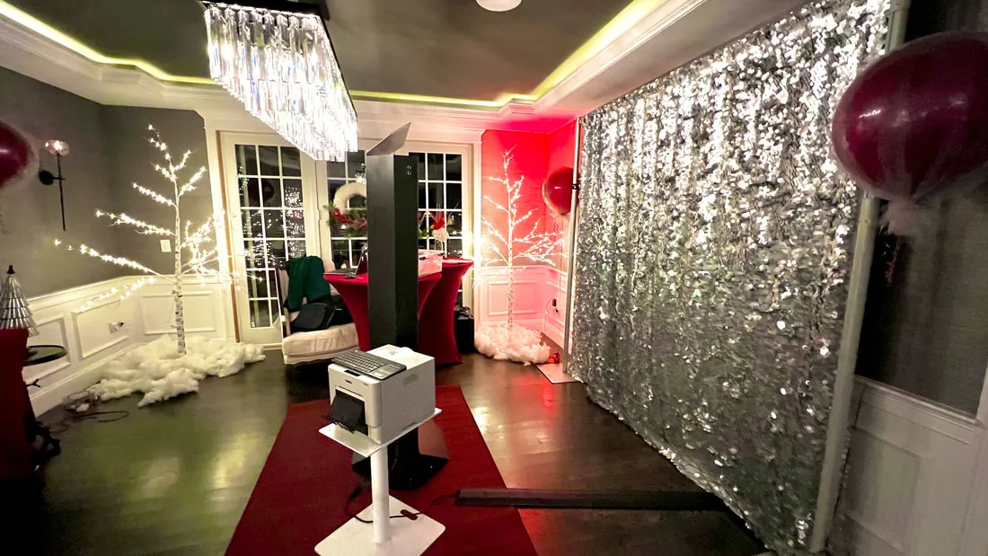 Mirror X booth setup with silver sequin backdrop and printer station