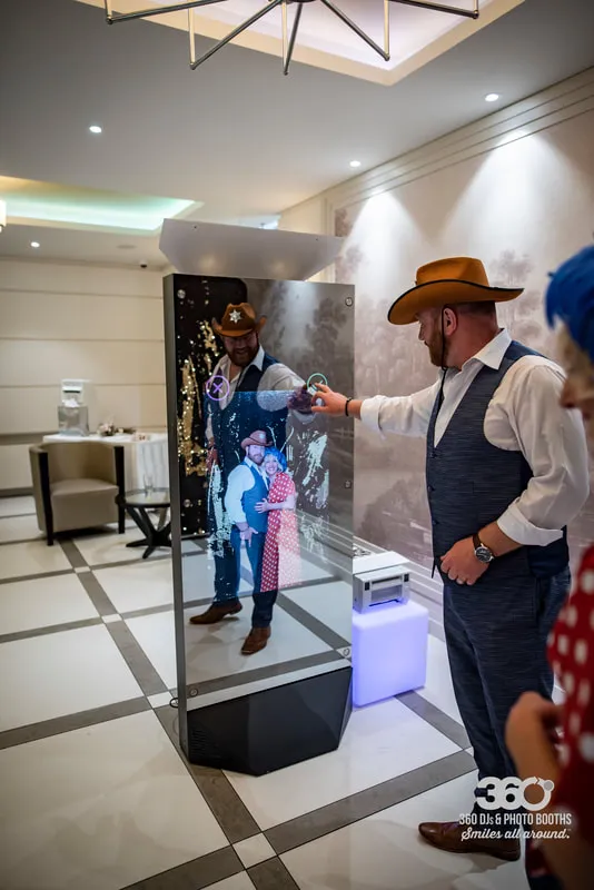 Mirror X photo booth guest interacting with the touchscreen mirror interface