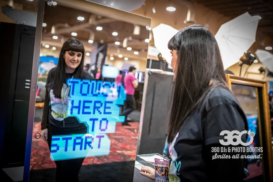 Mirror X mirror booth experience on a trade show floor with bright interface graphics