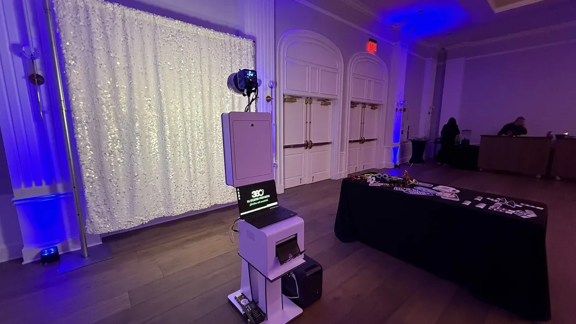 Open backdrop photo booth setup with professional lighting at a Boston wedding