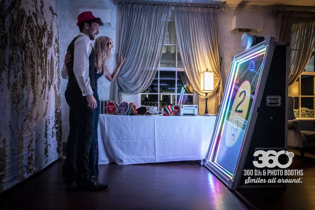 Selfie Mirror setup with illuminated frame and guests posing before the countdown