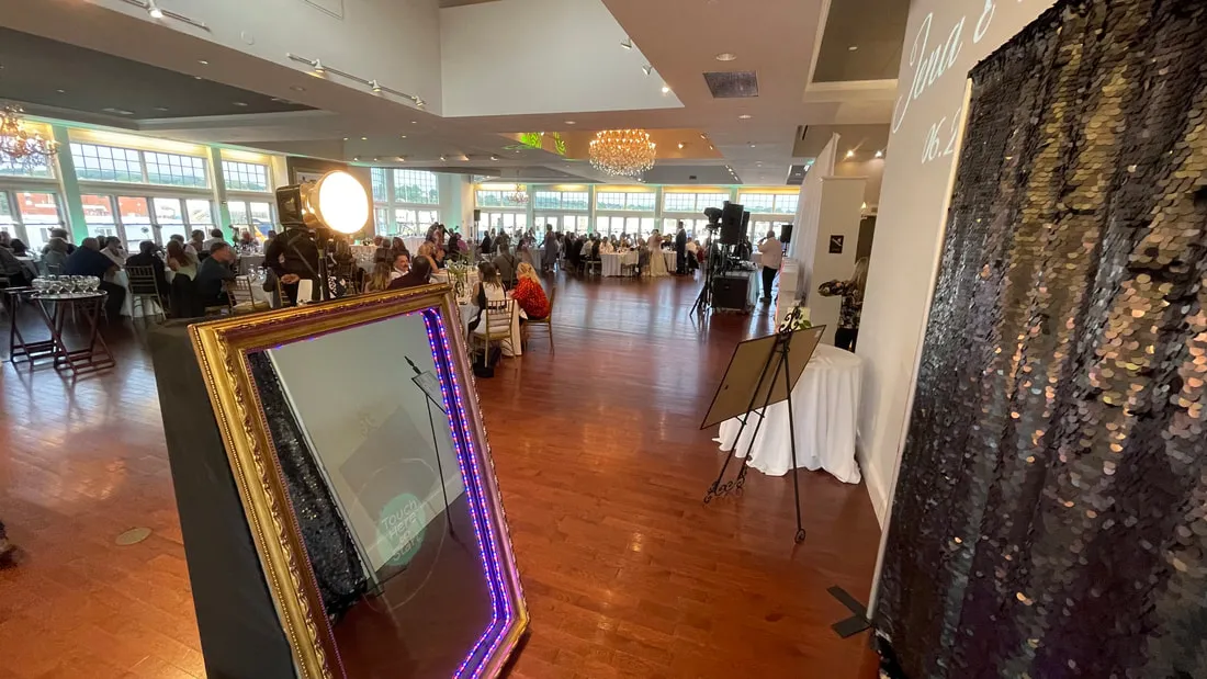 Selfie Mirror booth positioned beside a black sequin backdrop during a wedding reception