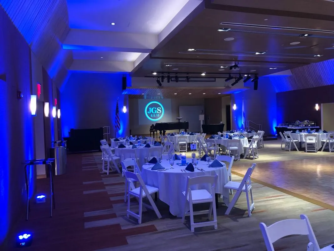 blue LED uplighting across a wedding reception venue